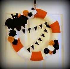 a halloween wreath is hanging on the door