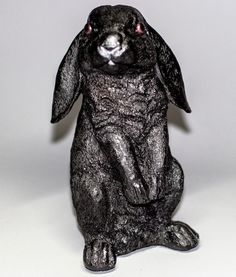 a black rabbit figurine sitting on its hind legs