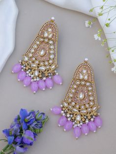 Unleash your inner diva with our lilac purple  mesmerizing Indian Kundan Earrings. Designed to make a bold statement, these earrings exude captivating splendor, blending traditional Indian aesthetics with contemporary allure. Crafted with meticulous attention to detail, these earrings showcase the artistry of Kundan work. The vibrant Kundan stones take center stage, radiating a luminous charm that catches every eye. The intricate setting in gleaming golden tones adds an element of opulence and e Festive Purple Chandbali Jewelry, Purple Earrings For Festivals, Purple Earrings For Festive Occasions, Purple Festive Earrings For Festivals, Festive Purple Meenakari Jewelry, Festive Bollywood Purple Jewelry, Festive Purple Bollywood Jewelry, Traditional Purple Jewelry For Diwali, Traditional Meenakari Purple Jewelry