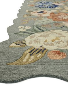 an area rug with flowers and leaves on the side, in various shades of gray