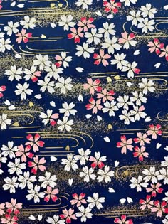 a blue background with pink and white flowers on it's side, gold lines in the middle