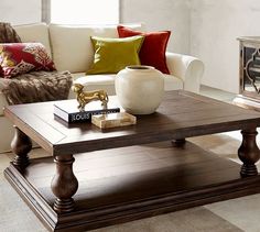 a living room filled with furniture and a fire place in the middle of the room