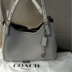 Coach Lori Leather Shoulder Bag In Color Chalk “New” ~It Is Beautiful~ Magnet Shut And Smells Rich Product Details Multiple Interior Compartments Keep Your Key Items Organized In Style With This Spacious Coach Shoulder Bag Designed In Soft Pebble Leather. 12-1/4"W X 10-1/4"H X 6"D (Width Is Measured Across The Bottom Of Handbag) Silhouette Is Based Off 5'9" Model 11"L Adjustable Handles Magnetic-Snap Closure Gold-Tone Exterior Hardware, Protective Feet, 1 Zip Pocket & Logo 1 Interior Snap Pocket Coach Lori Bag, White Shoulder Bag With Silver-tone Hardware For Office, White Bags With Leather Handles For Formal Occasions, White Formal Bags With Leather Handles, Formal White Bags With Leather Handles, White Satchel With Silver-tone Hardware For Office, White Office Satchel With Silver-tone Hardware, White Office Bags With Silver-tone Hardware, Coach White Shoulder Bag For Office