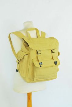 "100% Cotton Canvas Rucksack/Backpack - Various Colours Yellow - Blue - Khaki - Black Features: 1 x main front compartment 1 x front storage pocket 2 x side pockets Adjustable metal buckled straps and front fastenings. Easily fits a laptop Great for school, college, camping or simple everyday use Thick canvas cotton material Strong and well made product Ex-military Max capacity dimensions: 15\" x 15\" x 8.5\" (XL rucksack, fits all laptop sizes) Fabric: 100% thick cotton canvas. Condition: The c Yellow School Backpack With Pockets, Daily Use Backpack With Pockets And Flap, School Backpack With Flap Pockets, Daily Use Backpack With Flap And Pockets, Daily Use Flap Backpack With Pockets, Canvas Backpack With Multiple Pockets, Rectangular Backpack With Multiple Pockets For School, Rectangular Backpack With Multiple Pockets For Back To School, Functional Adventure Bags With Adjustable Straps