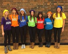 a group of young women standing next to each other in front of a brick wall