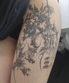 a woman's thigh with tattoos on it