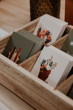 many cards are in a wooden box on the table