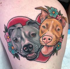 two dogs with flowers on their heads are in the shape of a heart, and one is