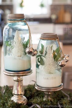 two glass jars filled with white frosted christmas decorations