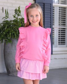 The Laura Girl's Ruffle Pullover in Pink is a darling addition to any young girl's wardrobe! With two rows of ruffles, this top is both cute and perfect for fall events like school and play dates. Stay stylish and cozy with this must-have piece! Cute Ruffle Sleeve Top With Ruffles, Playful Pink Ruffled Tops, Preppy Pink Tops For Fall, Cute Top With Ruffled Collar, Playful Ruffle Tops For Playwear, Playful Ruffled Tops For Playwear, Cute Ruffled Collar Tops For Fall, Playful Long Sleeve Tops With Ruffles, Cute Long Sleeve Sweater With Ruffles