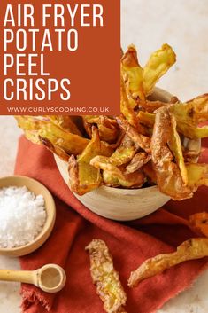 air fryer potato peel crispes in a bowl with salt and pepper on the side