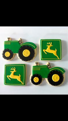 four green and yellow tractor shaped cookies with deer on the front, two are decorated like tractors