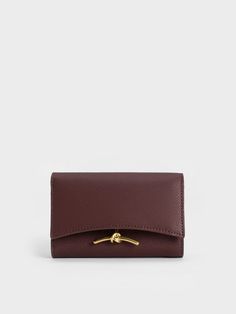 In a gorgeous chocolate brown, this neutral-toned Huxley wallet is made for those with a penchant for understated designs. From the sleek curved flap to the knotted gold-toned metallic accent, this accessory has a classic-with-a-twist design that will inject fun into your everyday outfit. Functional and sleek, this wallet has more than enough space to hold your essentials, while staying slim enough to slip into your bag or back pocket with ease. Designer Leather Wallet, Aesthetic Wallet, Wallet Aesthetic, Venus In Virgo, Adidas Outfits, House Balcony, Unique Wallets, More Than Enough, Brown Wallet