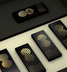 some black and gold business cards on a table