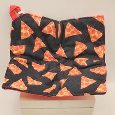 an orange and black bag with slices of pizza on it