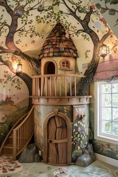 a room with a tree house painted on the wall and stairs leading up to it