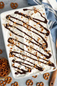 an ice cream sundae with chocolate drizzle and pretzels