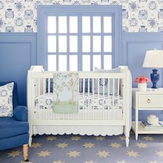 a baby's room with blue and white decor