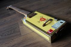 a small yellow instrument sitting on top of a wooden floor