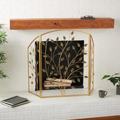 a fire place with books and plants on the mantle