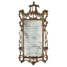 an ornately decorated mirror is shown against a white background