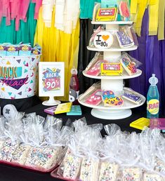 there are many items on the table for sale at this birthday party, including cupcakes and cookies