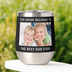 a stainless steel tumbler with the words, this drink belongs to the best dad ever