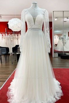 a white wedding dress on display in a store