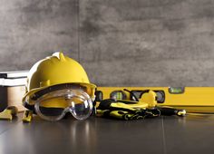 a hard hat, safety goggles and construction tools