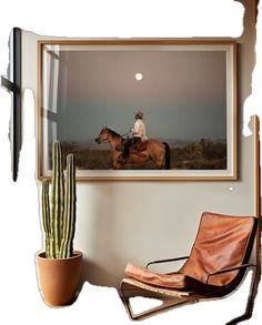 a person on a horse is sitting in a chair next to a cactus