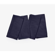 two dark blue napkins sitting on top of each other