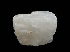 a large white rock sitting on top of a black surface