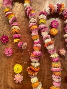 the flowers are laid out on the table and ready to be made into garlands