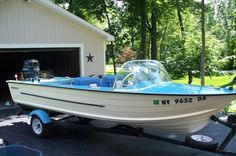 a small boat parked in front of a garage