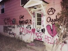 graffiti on the side of a pink house