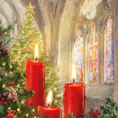 two red candles sitting next to a christmas tree in front of a stained glass window