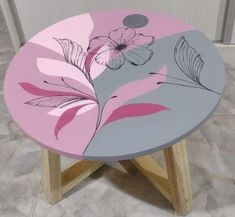 a pink and gray table with flowers painted on it