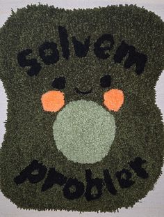 a black teddy bear with an orange nose and the words solven brooho written on it