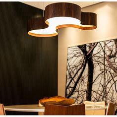 a dining room table with chairs and a painting on the wall