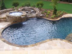 a large pool with a hot tub in the middle