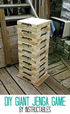 a stack of wooden blocks sitting on top of a wooden deck next to a tv