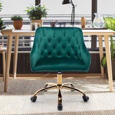 a green office chair sitting in front of a table with potted plants on it