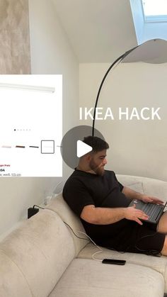 a man sitting on a couch with a laptop computer in his lap and the words ikea hack above him