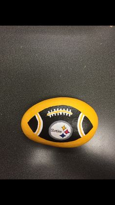 a yellow and black football sitting on top of a table