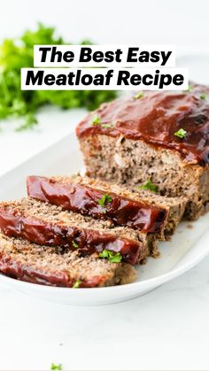 slices of meatloaf on a white plate with ketchup and parsley