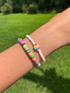 This fun bracelet stack comes with 1 multicolored clay bead bracelet and 1 seed bead bracelet. Each bracelet measures approximately 6.5 inches with stretch to accommodate various wrist sizes. Fun White Stretch Bracelet With Colorful Beads, Fun White Stretch Bracelet With Round Beads, Playful White Heishi Beads Stretch Bracelet, Fun White Beaded Stretch Bracelet, White Beaded Bracelets With Round Beads, Playful Multicolor Heishi Beads Stretch Bracelet, Playful Heishi Beads Stretch Bracelet, Fun White Heishi Beads Bracelet, Playful Beaded Stretch Bracelet