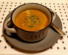 a bowl of soup is sitting on a plate