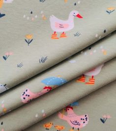 the fabric has ducks and umbrellas on it