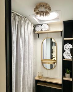 a bathroom with a sink, mirror and shower curtain in it's corner area