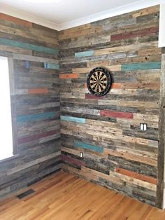 a room with wooden walls and a dart on the wall